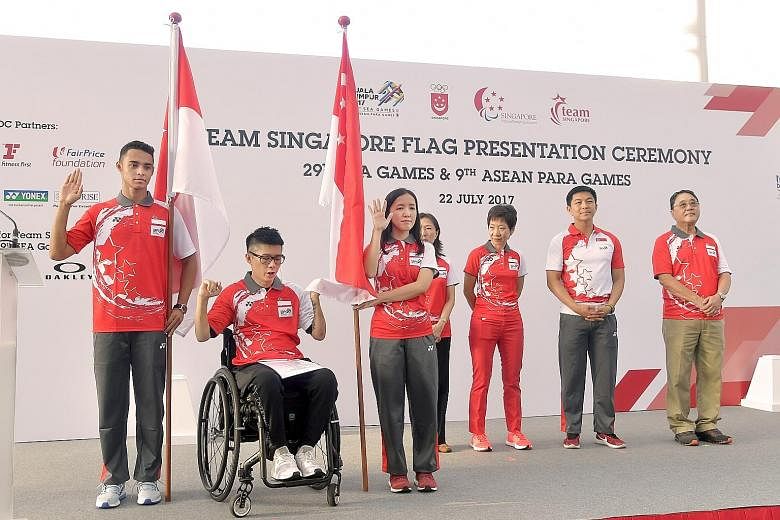 Taking the pledge at the SEA Games flag presentation ceremony yesterday were (from left) para athlete Suhairi Suhani, flag-bearer for the Asean Para Games, APG paddler Aaron Yeo and Jasmine Ser, flag-bearer for the SEA Games.