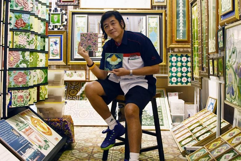 Mr Victor Lim at his Peranakan Tiles Gallery, showing examples of European Art Noveau and Japanese Art Deco tiles.