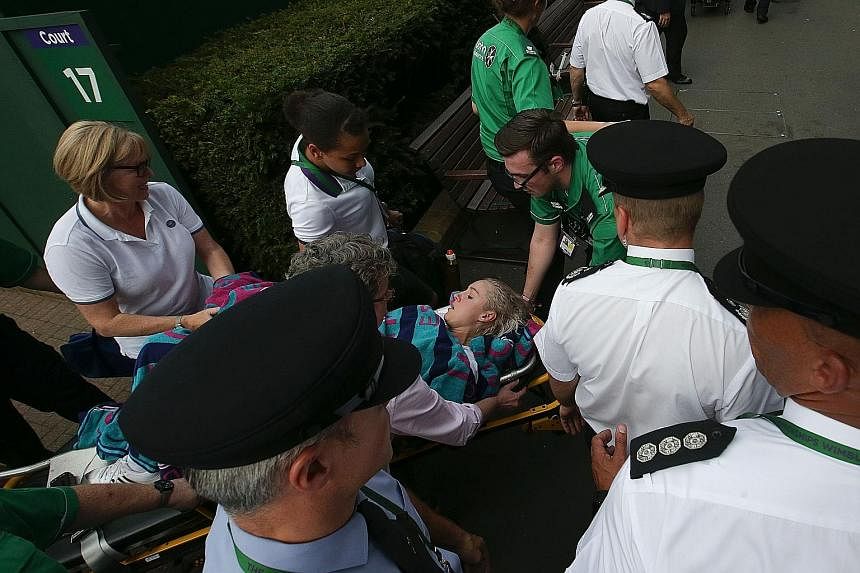 Above: Mattek-Sands leaving the Wimbledon court on a stretcher after her injury.