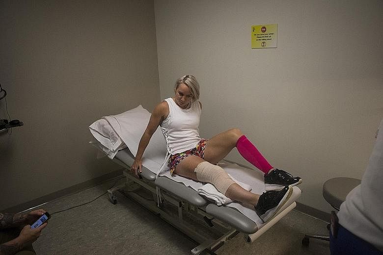 Above: Bethanie Mattek-Sands positions herself before her rehabilitation session in New York.