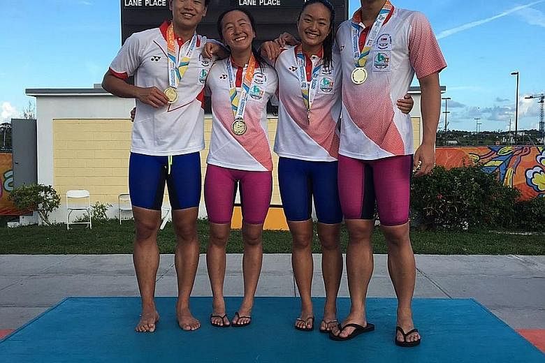 From left: Swimmers Samuel Khoo, 18, Quah Jing Wen, 16, Natasha Ong, 16 and Francis Fong, 17, posing with their Commonwealth Youth Games mixed 4x100m medley golds.