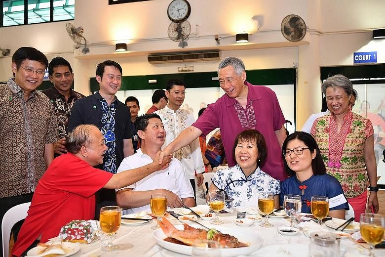 Prime Minister Lee Hsien Loong greeting Pioneer Generation Ambassador Koh Ting Beow, 67, at the lunch yesterday. With PM Lee were his wife, Mrs Lee, as well as (from left) fellow Ang Mo Kio GRC MPs Gan Thiam Poh and Darryl David, Sengkang West MP Lam