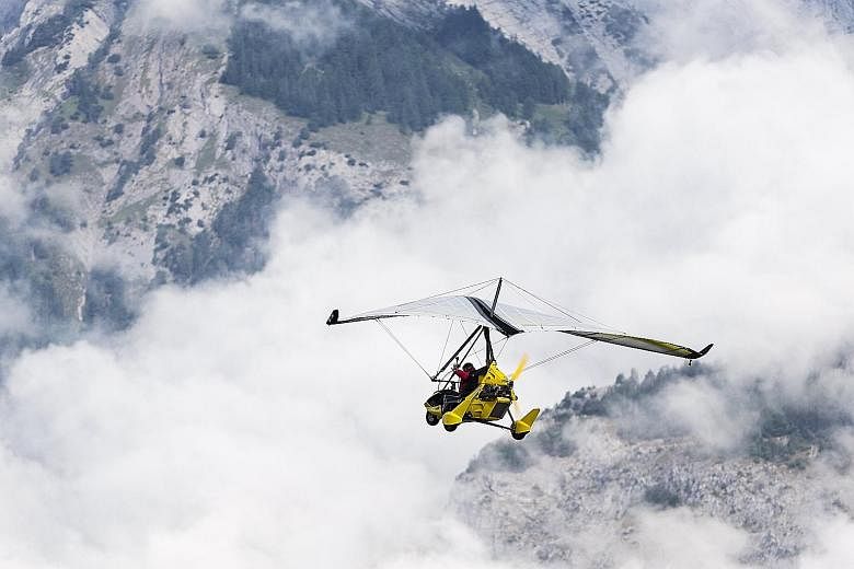 Swiss adventurer Xavier Rosset in his light sport aircraft on the first day of his Fly the World project, which began yesterday in Sion, Switzerland. This attempt to circumnavigate the world in 400 days will take him across five continents and 50 cou