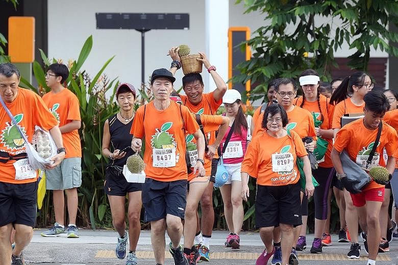 From egg cartons to styrofoam boxes, baskets and plain old gloves, Ang Mo Kio-Hougang residents yesterday came up with creative ways to hold a durian while they ran. About 500 people participated in the 5km durian run yesterday. They paid $15 to take