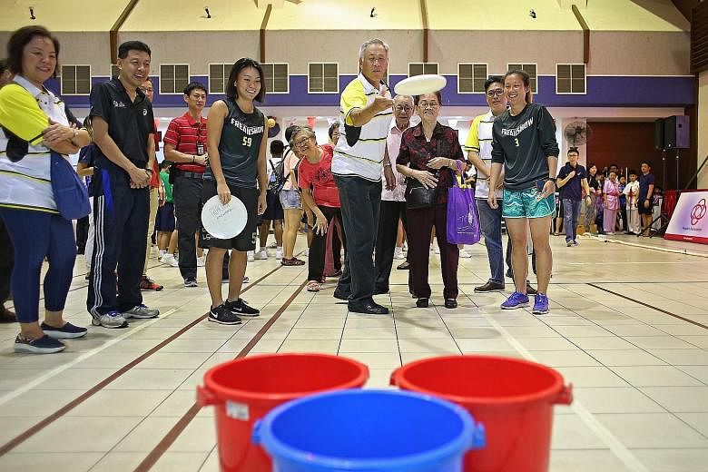 "Sports is quite an antidote to the different forces that are pulling communities apart," said Defence Minister Ng Eng Hen (centre), seen at a community sports day organised by the People's Association in Toa Payoh.