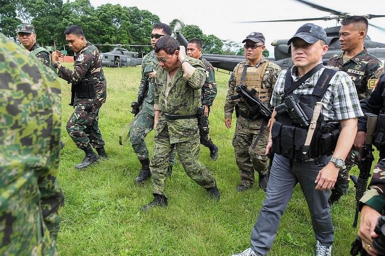 Philippine President Rodrigo Duterte arriving at the military camp in Marawi city, Mindanao, last Thursday. The battle against Islamist militants there is now in its third month.