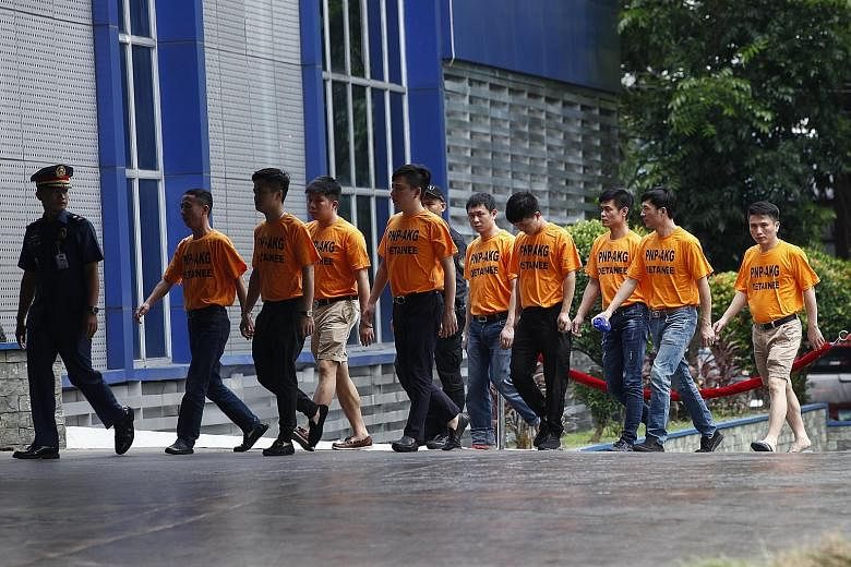 Some of the suspects in the kidnapping case being taken to the Philippine National Police headquarters in Quezon City, east of Manila, last week.