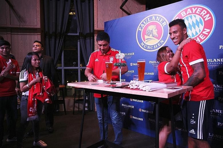A fan embracing Bayern Munich midfielder Corentin Tolisso during a meet-and-greet session at German restaurant Paulaner Brauhaus. The French international has a tough task ahead to secure a starting berth.
