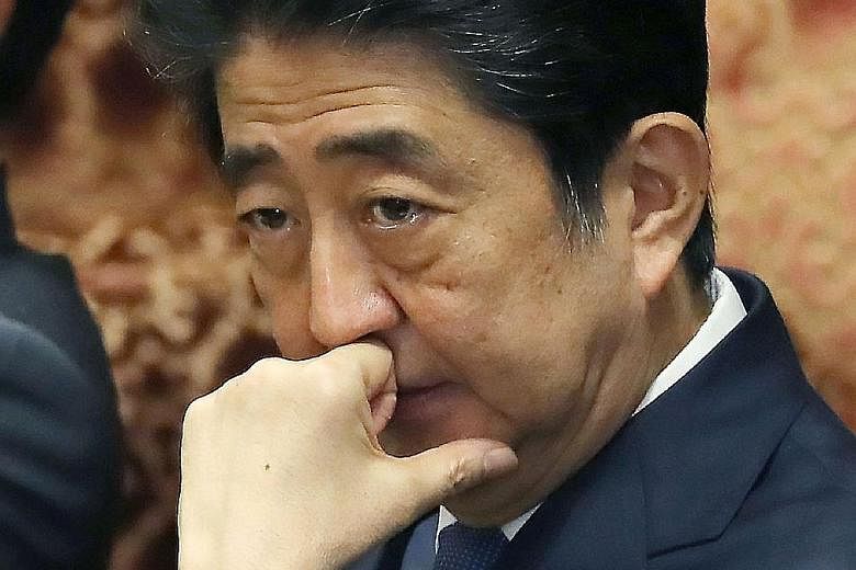 Japanese Prime Minister Shinzo Abe at yesterday's Lower House session. He is fighting allegations that he pulled strings to help educational institution Kake Gakuen, which is run by his close friend Kotaro Kake, win a bid to set up a veterinary schoo
