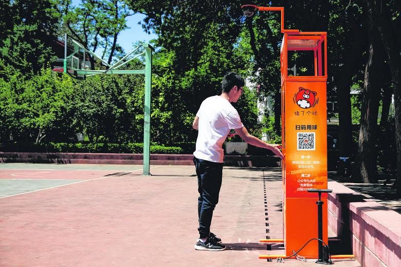 Enterprising businesses are making convenience their selling point as they offer users instant access to almost anything they need or lack, from umbrellas in Shanghai (far left) to basketballs at a Beijing university (left). A customer in Shanghai sc