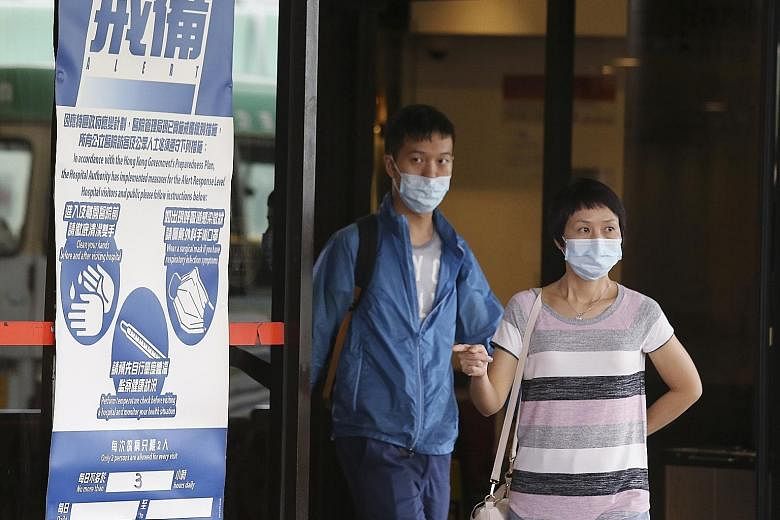 Notices at Queen Mary Hospital in Hong Kong alerting the public that the serious influenza pandemic response level has been activated. Since May, 205 adults and three children have died.
