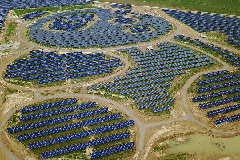 An aerial view of a panda-shaped solar farm built by Panda Green Energy Group in Datong, Shanxi province. The plant is built with darker crystalline silicon and lighter-coloured thin film solar cells, and resembles a giant cartoon panda from the air.