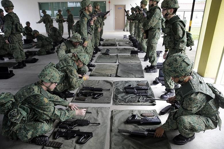 Recruits practising weapons handling at the Singapore Armed Forces Basic Military Training Centre in Pulau Tekong. The High Court set out written reasons for why NS dodgers who return to Singapore past the age of 40 should get sentences close to thre