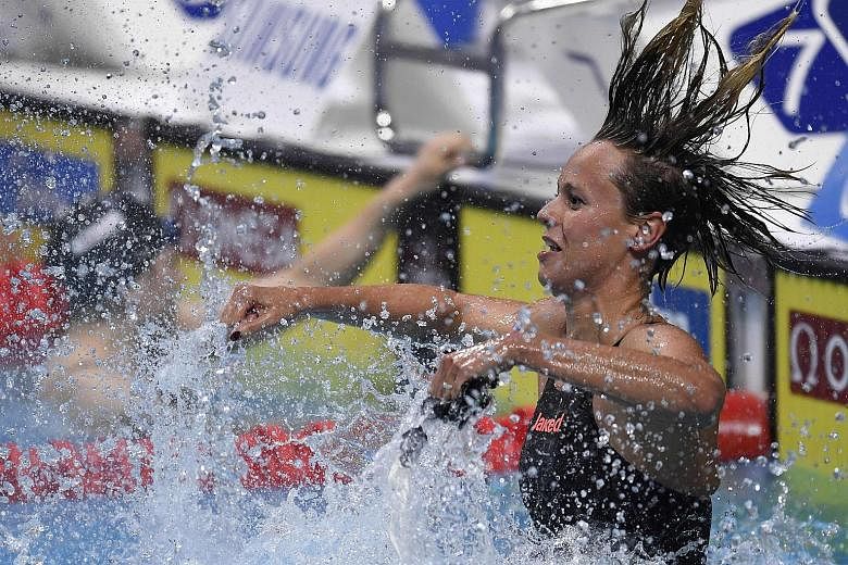 Italy's Federica Pellegrini celebrates after winning the women's 200m freestyle final at the world championships in Budapest.
