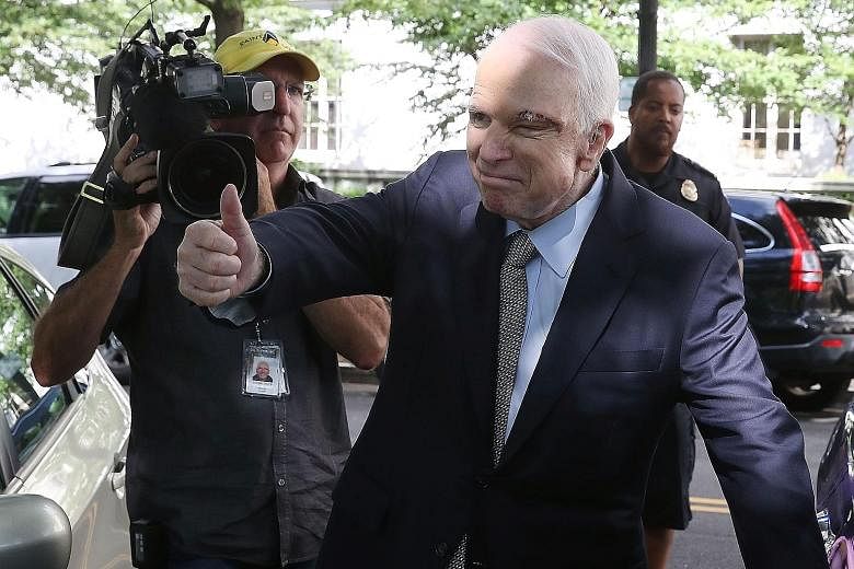 Senator John McCain, just diagnosed with brain cancer, giving the thumbs up to well wishers outside the US Capitol on Tuesday. The Republican returned to the Senate floor, delivering his party the critical 50th vote to begin debate on an unknown plan