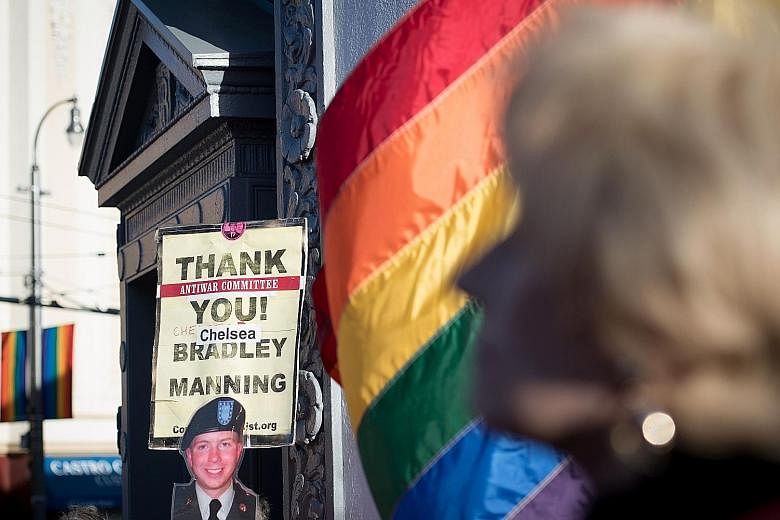 People holding up signs during a celebration in California for transgender soldier Chelsea Manning's release in May. Late last month, Defence Secretary Jim Mattis approved a six-month delay in allowing transgender recruits to join the United States m