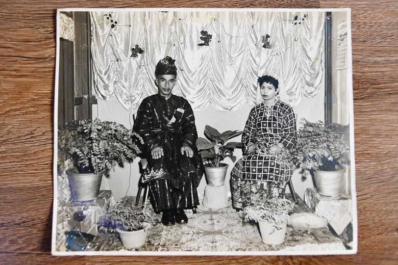 Left: Madam Zulaika Mohamad Osman holding a photo of her 1961 wedding with Mr Ismail Awang (enlarged version on top) outside her Circuit Road home. Above: Some of Madam Zulaika's family photos, including two of her children and their families, and a 