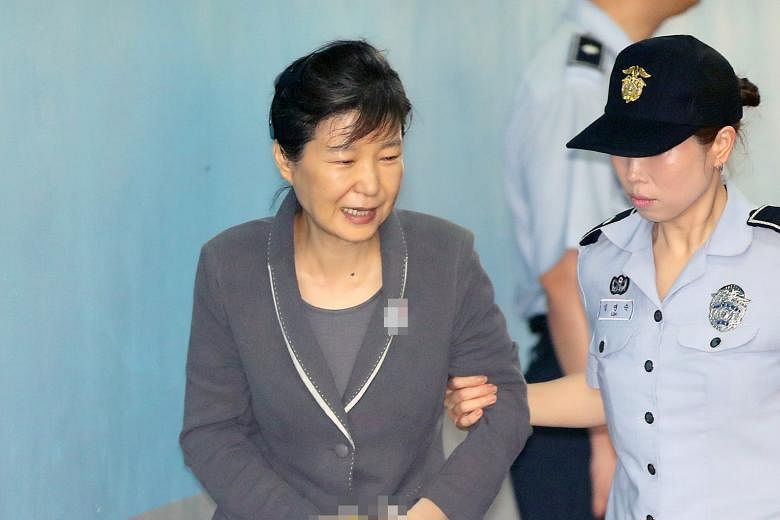 On Tuesday, prosecutors said ousted president Park Geun Hye (above) met Samsung heir Lee Jae Yong (right) secretly three times and discussed bribes in return for policy favours.