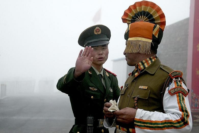 A Chinese soldier and an Indian soldier at a border crossing between the two countries.