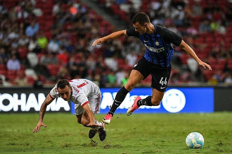 Inter Milan winger Ivan Perisic (right) and Bayern Munich right-back Rafinha in a tussle for the ball during the ICC friendly at the National Stadium yesterday. Chelsea will play Inter tomorrow evening in the final match.