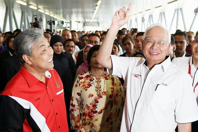 Malaysian Prime Minister Najib Razak (right) and DPM Ahmad Zahid Hamidi (left) at Kajang station last week for the launch of the MRT Sungai Buloh-Kajang line in Kuala Lumpur. The BN has been in power since independence in 1957, making it the longest-