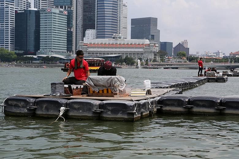A member of the NDP 2017 Fireworks Committee setting up the fireworks at one of the 69 pyrotechnic mounting points on a mid-level barge at The Float @ Marina Bay yesterday.
