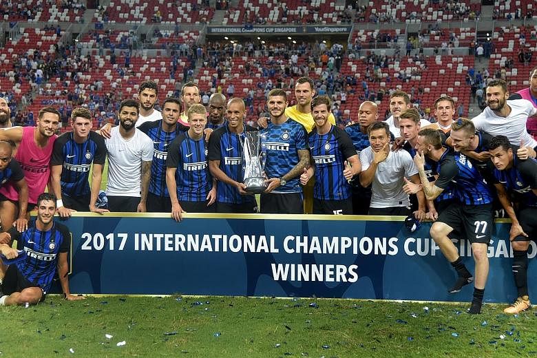 Inter Milan's Joao Miranda and Mauro Icardi (third from right) pose with the International Champions Cup Singapore trophy after their 2-1 win over Chelsea. The Italian side won both their matches against their more fancied opponents, having also defe
