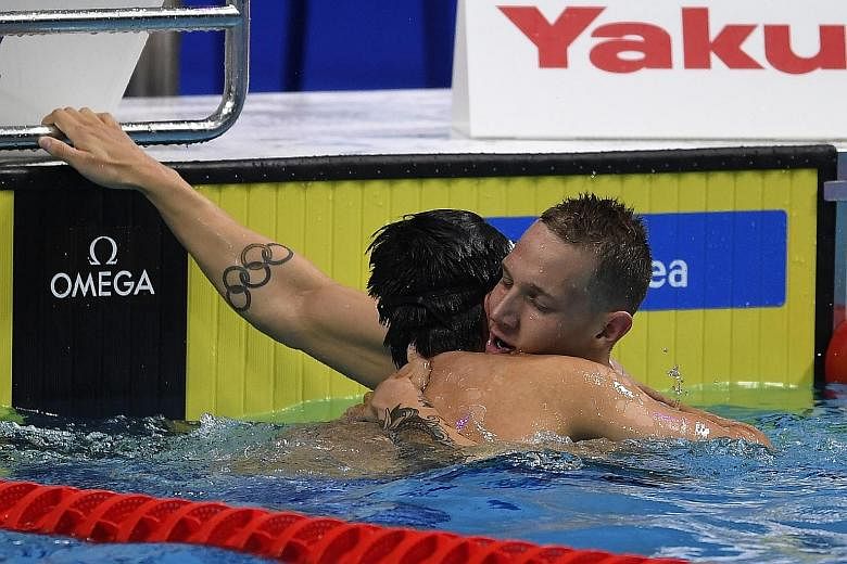 Joseph Schooling embracing Caeleb Dressel, who was a class above the rest in the 100m butterfly final. The American swam 49.86sec, just 0.04 off the world record, to win his fifth gold.
