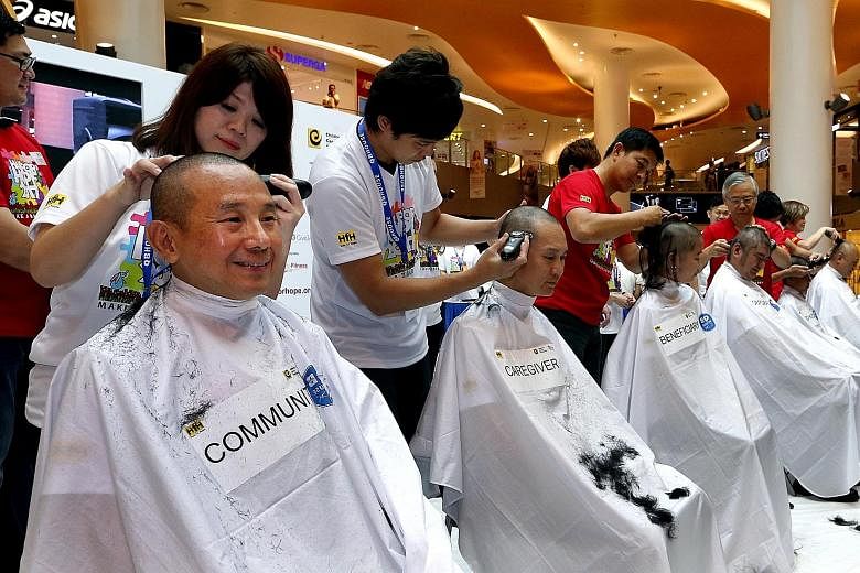 Film producer Daniel Yun (right), known for being the man behind some of Singapore's best-known films such as I Not Stupid, was among the many who had their heads shaved at the annual Hair for Hope event yesterday, held to raise funds for and increas