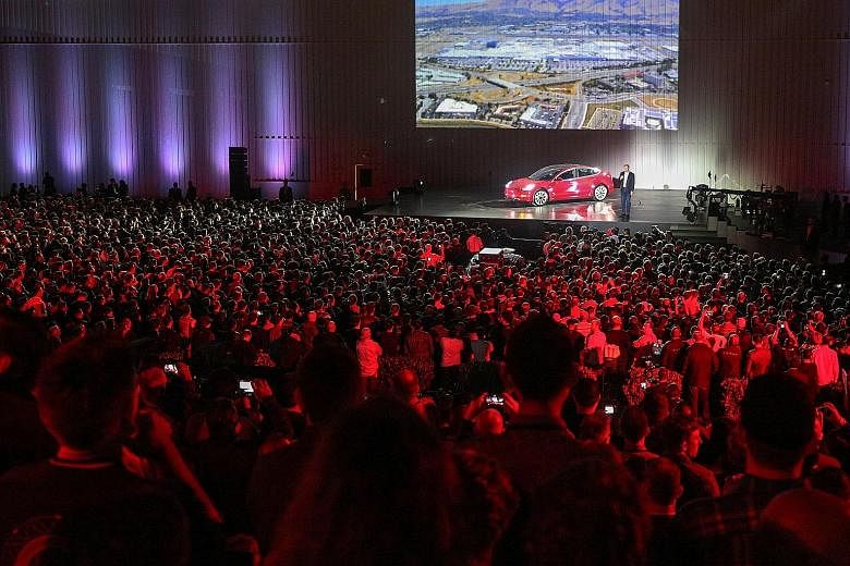 Tesla chief executive Elon Musk introducing one of the first Model 3 cars from the Fremont factory's production line at the company's facilities in California on Friday.