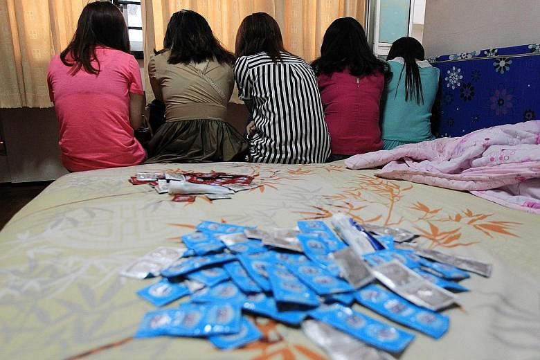 Sex workers in an illegal brothel. Non-governmental organisations here wish to raise awareness of the plight of trafficking victims.