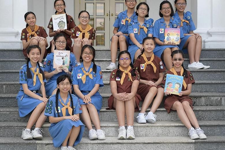 The books, by teams from (clockwise from bottom left) Methodist Girls' School, Holy Innocents' Primary School, River Valley High School and Haig Girls' School, mark the 100th anniversary of Girl Guides Singapore.
