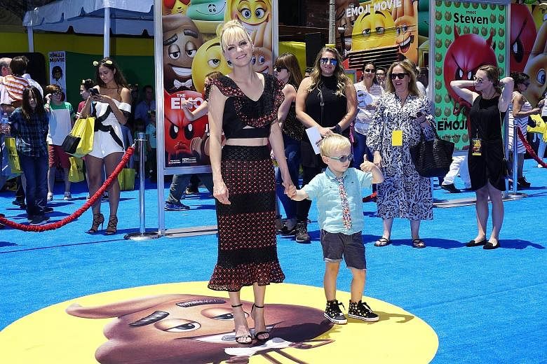 Actress Anna Faris (with her son Jack) at the Los Angeles premiere of The Emoji Movie, in which she voices a character named Jailbreak.