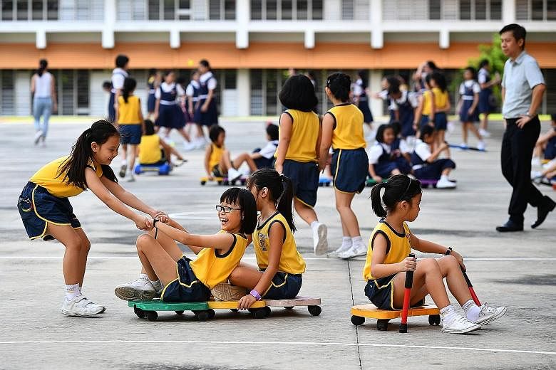 Paya Lebar Methodist Girls' School (Primary) pupils having fun during recess. The school's pupils can borrow equipment such as frisbees, badminton racquets, skipping ropes and roller racers during such breaks, with parent helpers and school staff on 