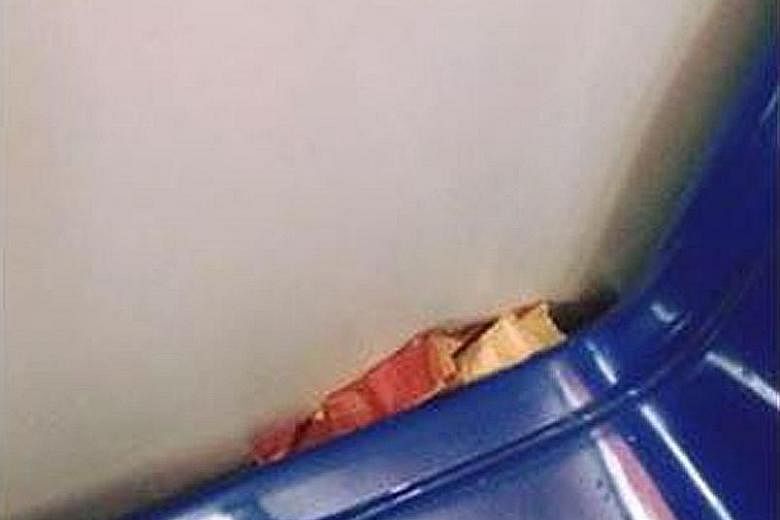 Pictures posted by RapidKL on Facebook show bread stuffed down the side of a seat (above) and a man doing chin-ups in a train. RapidKL uses witty posts to remind people of dos and don'ts on trains.