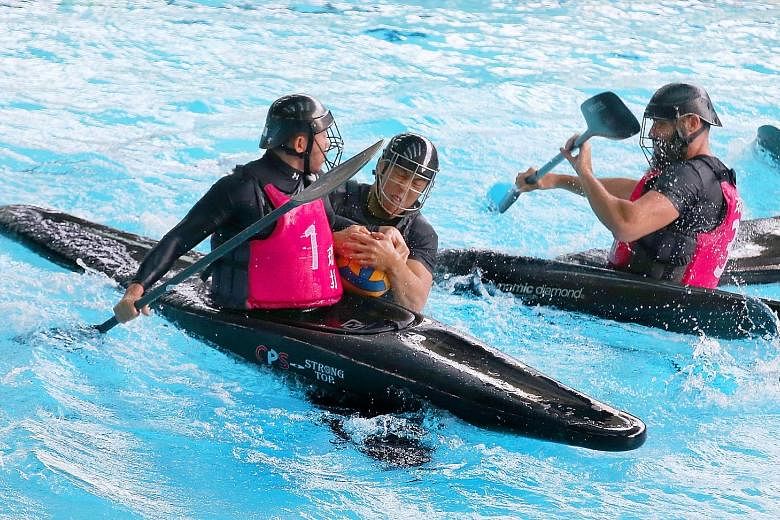 Mogui's Shawn Ng (centre) battling for the ball with XDNH's Poh Tai Cong (left) during the National Canoe Polo Championships men's open final yesterday. Ng's goal was the winner as Mogui ran out first-time winners.