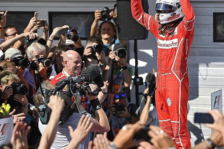 Sebastian Vettel after winning the Hungarian Grand Prix yesterday. His victory, with Lewis Hamilton finishing in fourth place, extended the German's lead in the World Championship to 14 points as the Formula One teams head into the traditional four-w