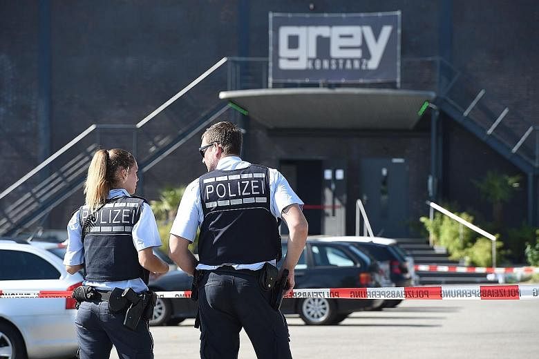Policemen in front of the Grey disco in the southern German town of Konstanz, where a gunman opened fire, killing one person and wounding three seriously.