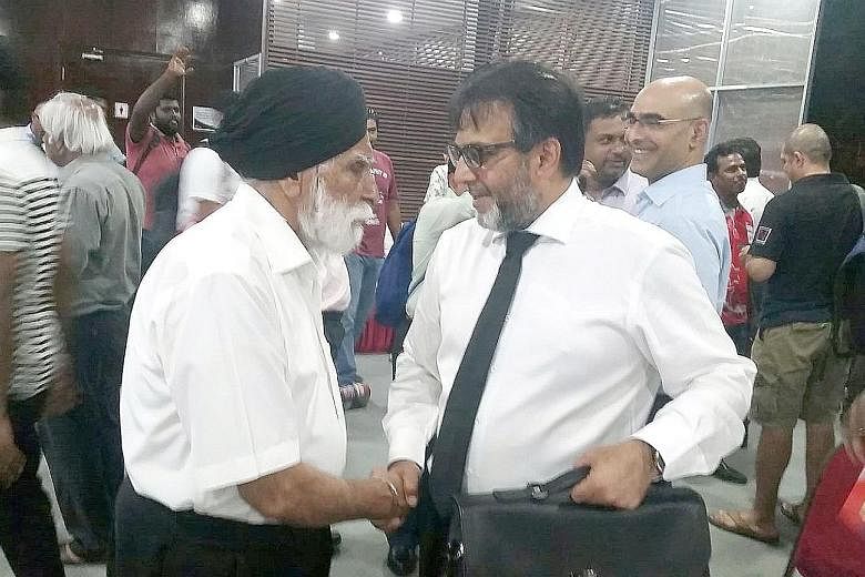 Mahmood Gaznavi being congratulated by Harbans Singh, a Singapore Cricket Association life member and a former president.