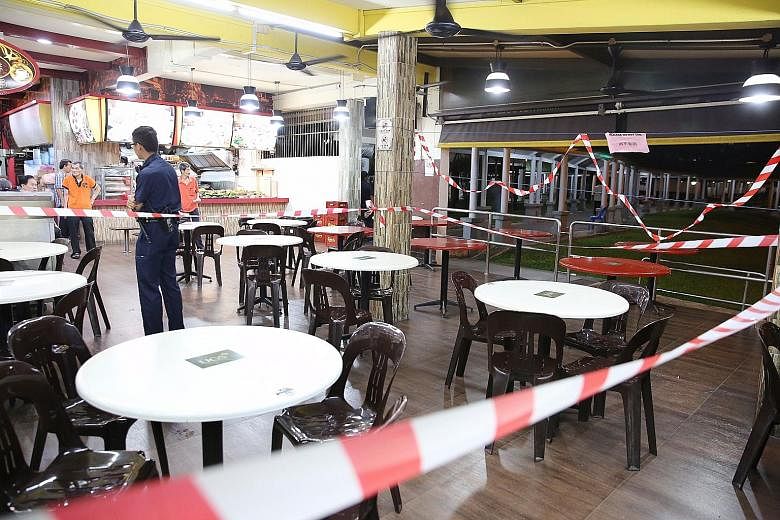 Khor Tzoong Meng (at left) was sentenced to jail yesterday after he pleaded guilty to a charge of culpable homicide for slashing Mr Ang Kim Keat. The coffee shop (below) in Hougang Avenue 3 was cordoned off after the incident on Feb 25 last year.