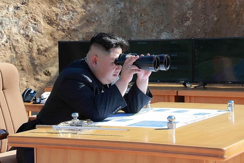 North Korean leader Kim Jong Un observing the test-firing of the Hwasong-14 intercontinental ballistic missile in this undated photo released by the Korean Central News Agency on July 4. The map on his table has come under intense scrutiny, and purpo