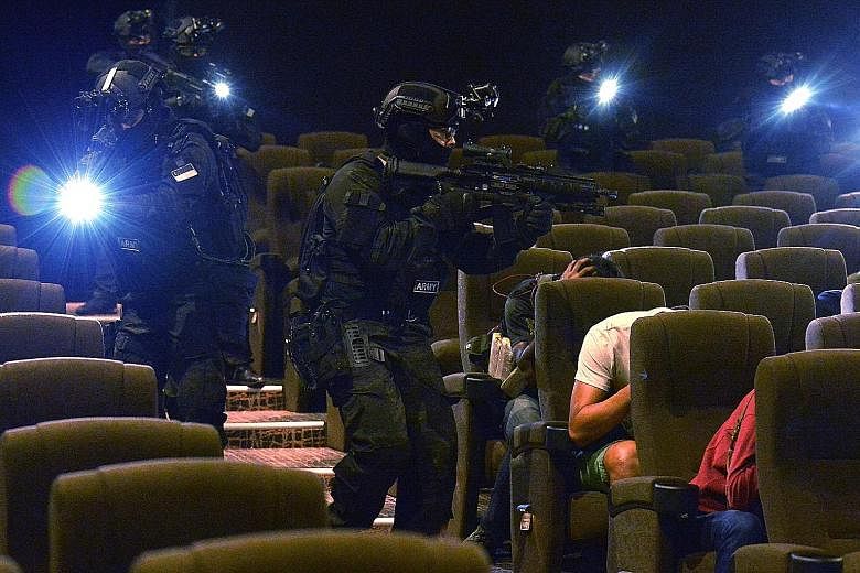 The SAF's Special Operations Task Force in a media preview of a counter-terrorism exercise last October in a cinema hall at Tampines Mall. Apart from acquiring new hardware, the SAF has updated its tactics, techniques and procedures for counter-terro