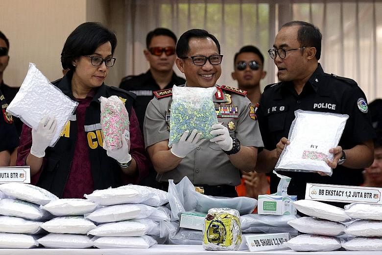 (From left) Indonesia's Finance Minister Sri Mulyani Indrawati, national police chief General Tito Karnavian and Criminal Investigation Department narcotics division head Eko Daniyanto at a press conference yesterday announcing the seizure of at leas
