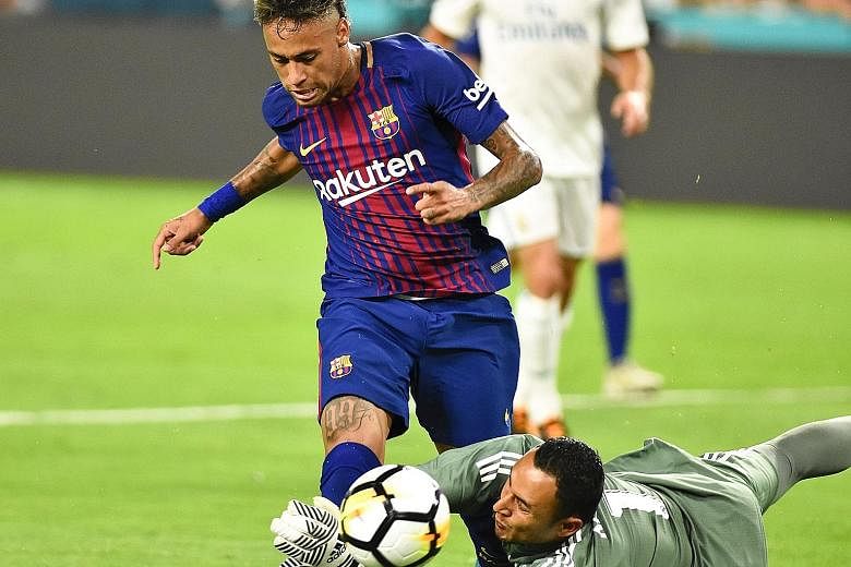 Barcelona's Neymar in action against Real Madrid goalkeeper Keylor Navas during a pre-season International Champions Cup match at the Hard Rock Stadium in Miami, Florida. The forward had agreed to a renewal bonus with Barcelona last year when he exte