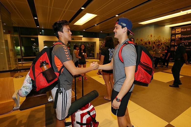 Singapore swimmers Quah Zheng Wen (far left) and Joseph Schooling bidding farewell at Changi Airport Terminal One after being together at last week's World Championships in Budapest. The duo will meet up again later this month to lead Singapore's nat