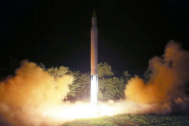 This picture released by North Korealast Saturday shows its intercontinental ballistic missile, Hwasong-14, being launched the day before.