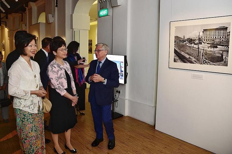 Mr Lee Fook Chee selling photos at The Peak in Hong Kong. Mr Edward Stokes, who discovered Mr Lee Fook Chee's collection of vintage photos, with Hong Kong Chief Executive Carrie Lam (second from left) and Ms Sim Ann, Senior Minister of State for Cult