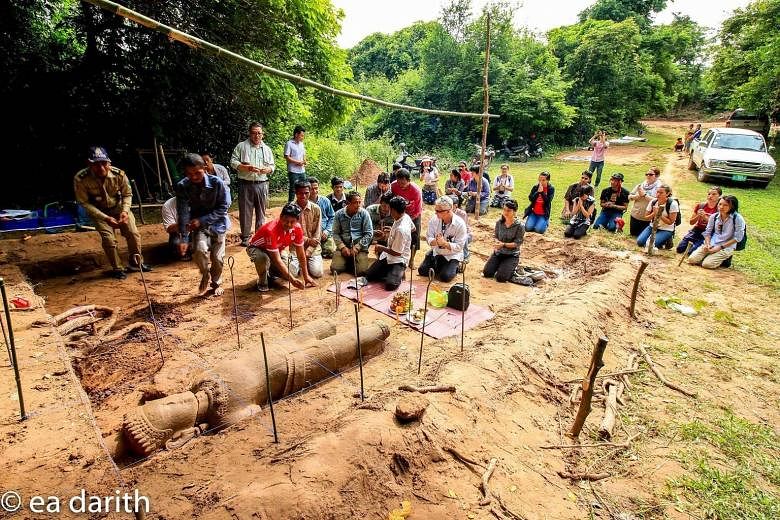 The field team from ISEAS - Yusof Ishak Institute's Nalanda- Sriwijaya Centre, led by Dr Kyle Latinis, with members of other teams at the site of the dig. Buried in a pit about 40cm deep, the approximately 2m-tall sandstone statue, sculpted in the im