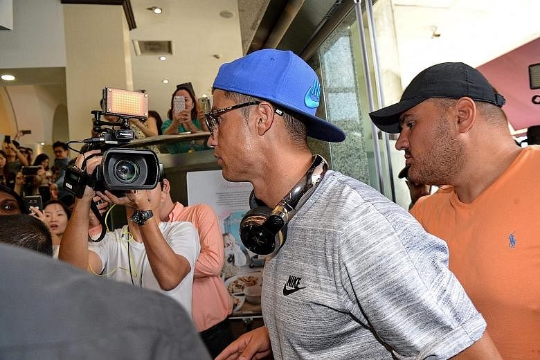 Global superstar Cristiano Ronaldo (centre) arriving at Thomson Medical Centre during a trip to Singapore last month.