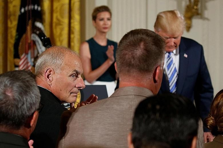 New White House chief of staff John Kelly (facing right) - at President Donald Trump's speech during a small business event at the White House on Tuesday - is seeking to streamline staff reporting directly to Mr Trump. Meanwhile, the US President has